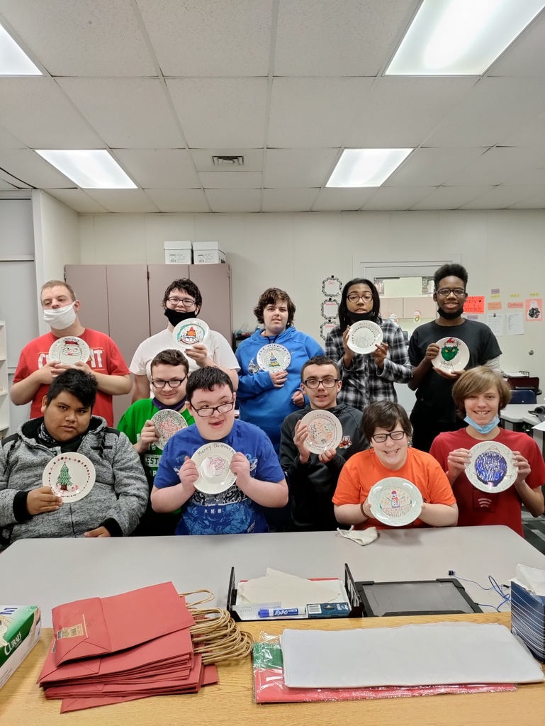 students holding ceramic plates