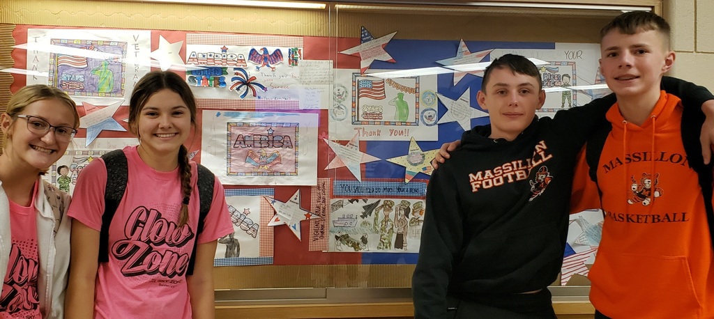 students in front of bulletin board