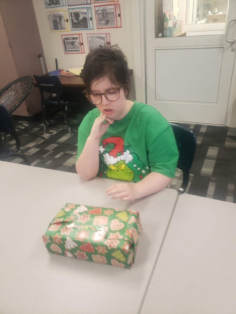 student wrapping gift