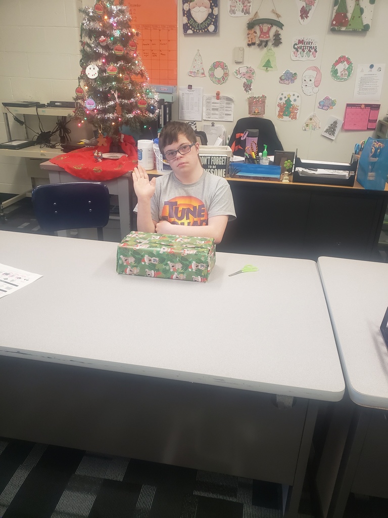 student wrapping gift